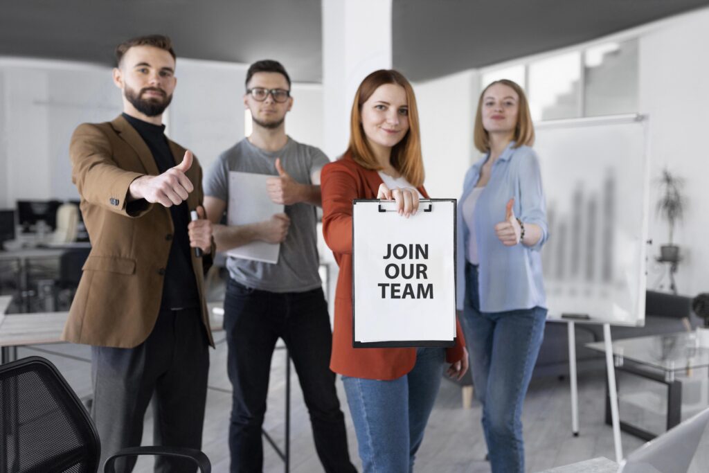 woman holding clipboard with join our team message (1)