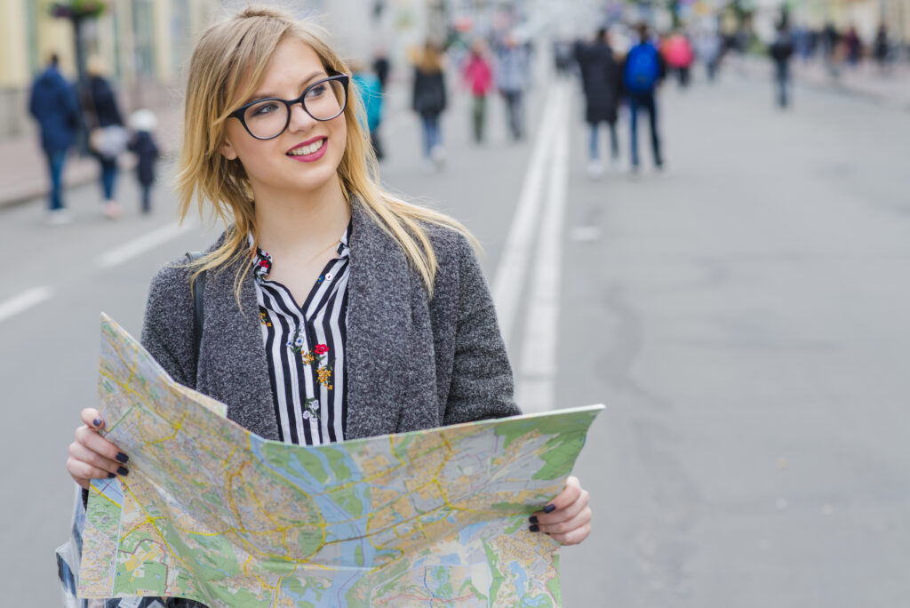 dreamy smiling woman with map