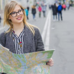 dreamy smiling woman with map